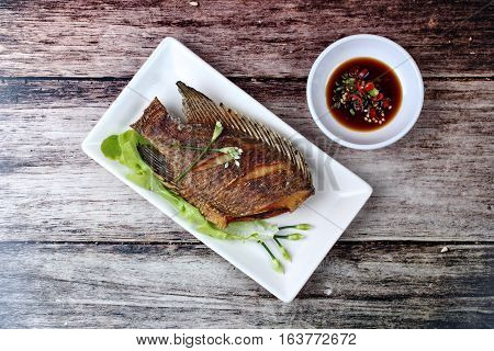 Deep Fried Little Tilapia Fish Served With Spicy Bean Sauce.
