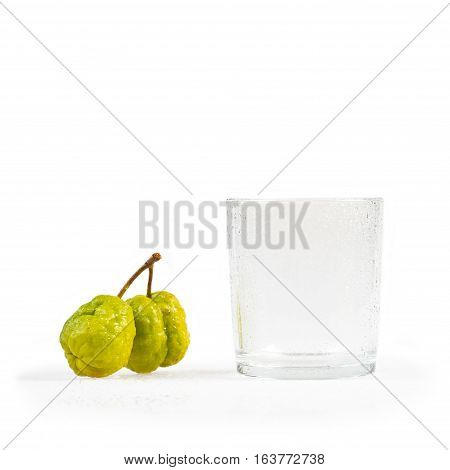 Chaenomeles japonica. Japanese Flowering Quince fruits and glass with water droplets