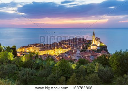 Romantic colorful sunset over picturesque old costal town Piran, Slovenia. Senic panoramic view.