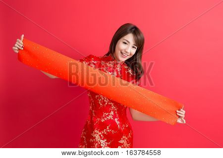 beauty woman wear cheongsam and show couplets with chinese new year