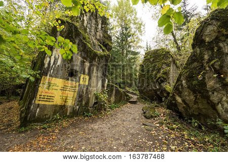 Wolf's Lair Adolf Hitler's Bunker in Poland. First Eastern Front military headquarters in World War II. Complex was blown up and abandoned on 1945. Autumn chaparral grown ruins trees leaves.