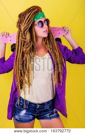 Portrait Of A Young Girl With Skateboard