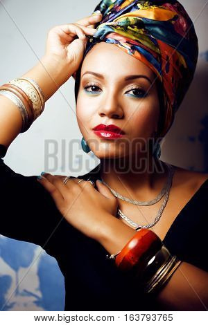 beauty bright real african woman with creative make up, shawl on head like cubian closeup smiling
