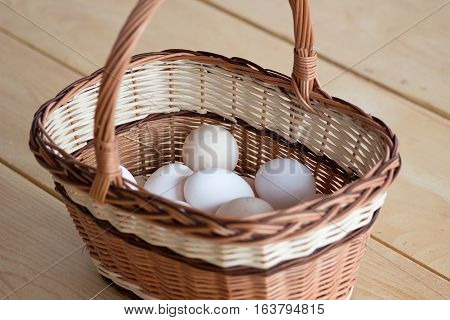 Quality chicken eggs from domestic breeding in a wicker basket