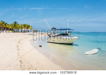 Le Morne Mauritius - December 7 2015: A sunny day with speed boat on the Le Morne Beach one of the finest beaches in Mauritius and the site of many tourism facilities.