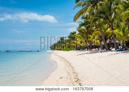 Le Morne Mauritius - December 7 2015: People relax on the Le Morne Beach one of the finest beaches in Mauritius and the site of many hotels and tourism facilities.