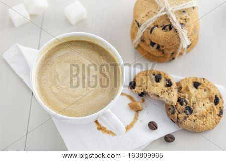 Cup of coffee with cookies on table for breakfast. Coffee break with chocolate biscuits. Top view.
