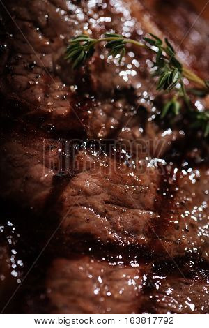 Delicious meat. Close up of tasty juicy steak being cooked in a restaurant and lying ob a table.