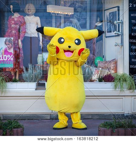 KIEV UKRAINE - SEPTEMBER 17 2016: Happy Pokemon Pikachu mascot near shop showcase in Kiev Ukraine.