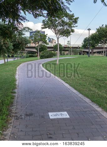 Bike lane between trees in Jardin del Turia in Valencia Spain, cycleway signposted a ground bikeway for cyclists only