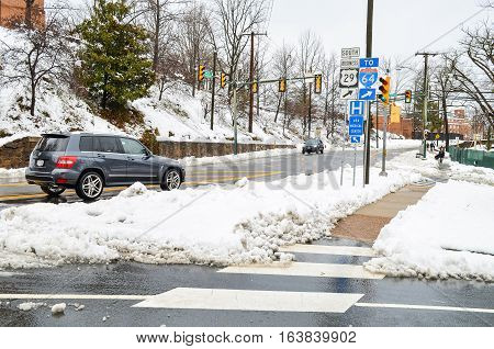 Charlottesville, USA - March 6, 2013: Jefferson Park Avenue after snow storm with cars and street signs