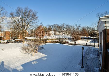 Charlottesville, USA - January 24 2013: Students of the Univeristy of Virginia walk to and from class on campus grounds during winter snow