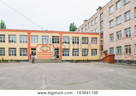 Rivne, Ukraine - May 14 2013: Secondary school number 13 entrance with people walking