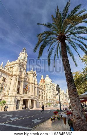Valencia Spain - December 25 2016: People in City Center with Town Hall in Plaza del Ayuntamiento.