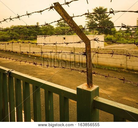 A rusty barbed wire fence at Kariadi General Hospital photo taken in Semarang Indonesia java