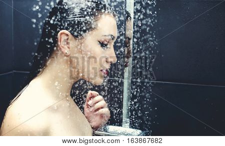 Beautiful sexy  young woman washing body in a shower