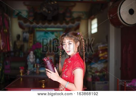 Chinese woman in traditional cheongsam in the new year in the Shrine