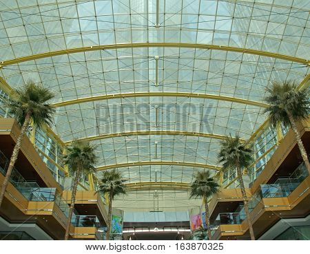 DETROIT - May 3, 2016.  On entering the Wintergarden in the Detroit Renaissance Center in downtown Detroit, Michigan, visitors will notice tall palm trees lining each side of the atrium. Overhead is a large glass area through which towers of the RenCen, t