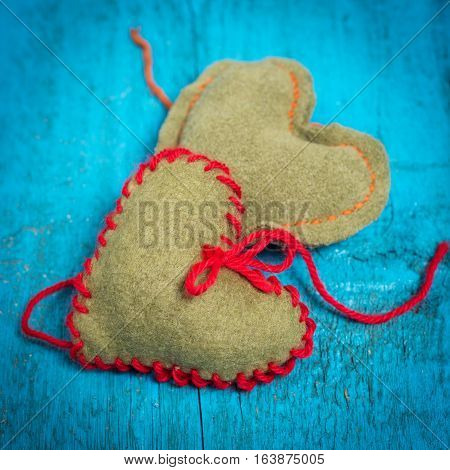 Valentine's Day. Colorful knitted hearts. Red heart on the blue boards. Valentines day. Heart pendant. Red heart. Valentine cards. Space for text. Eighth of March. International Women's Day.