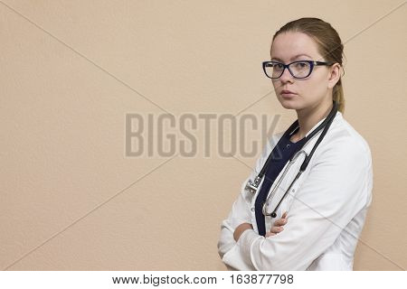 Real female doctor with the red stethoscope in medical uniform