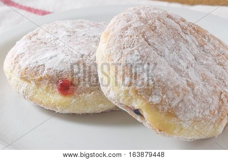 Food and Bakery Two Delicious Sweet Donuts Strawberry Jam and Blueberry Jam with Icing Toppings.