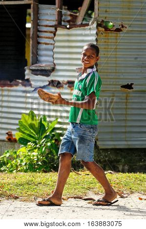 Lavena, Fiji - November 27: Unidentified Boy Walks In Lavena Village On November 27, 2013 On Teveuni