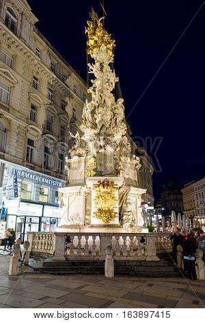 VIENNA, AUSTRIA - MAY 17, 2016: Photo view on memorial plague column pestsaule and tourists on graben street at night with people
