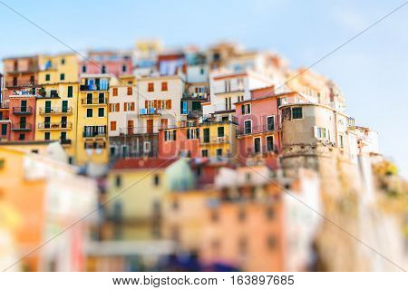 Colorful Manarola houses in Cinque Terre Italy. Miniature tilt shift lens effect.