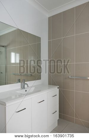 Contemporary style bathroom with vanity tiled wall