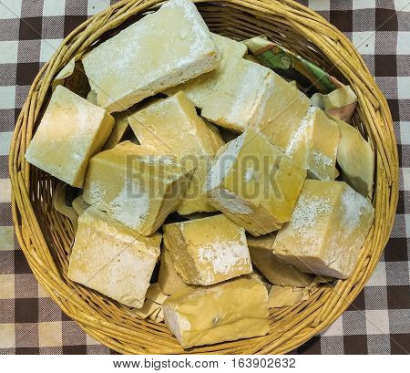 Top view of yellow organic handmade soaps in a basket