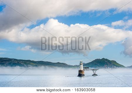 Roman Rock Lighthouse in False Bay. Standing at the entrance to Simonstown Harbour on a rock that is submerged at high tide but exposed at low water. South Africa