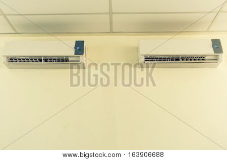 Air conditioner split type embed on wall of living room. Twin air conditioning.