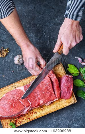 Woman In The Kitchen Is Cutting Beef