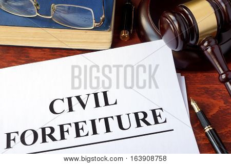 Civil forfeiture, documents and gavel on a table.