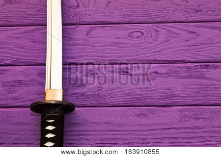 japan katana sword on the purple wood background