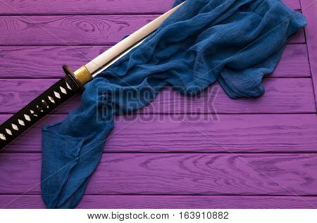 japan katana sword on the purple wood background