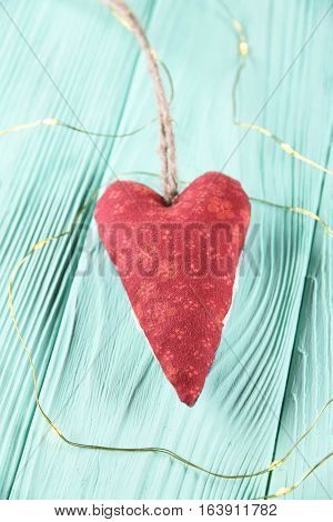 red heart on a mint wooden background