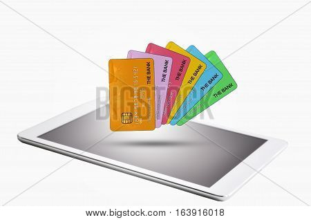 Tablet with multiple credit cards on white background