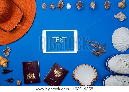 Tourism concept. Explorer equipment on wooden background, top view, wallet, tablet, passport