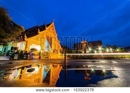 Wat Phra Singh temple at twilight or dawn. This temple contains supreme examples of Lanna art in the old city center of Chiang MaiThailand.