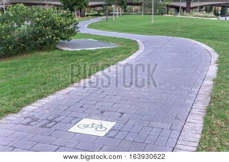 cycleway signposted a ground bikeway for cyclists only. Bike lane between trees in Jardin del Turia in Valencia Spain