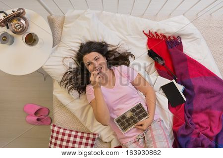 Happy Single Woman Eating Chocolates