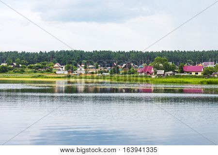 River Karakan the village of Zavyalovo Novosibirsk oblast Siberia Russia - July 7 2016: a view of the ancient Siberian village across the river