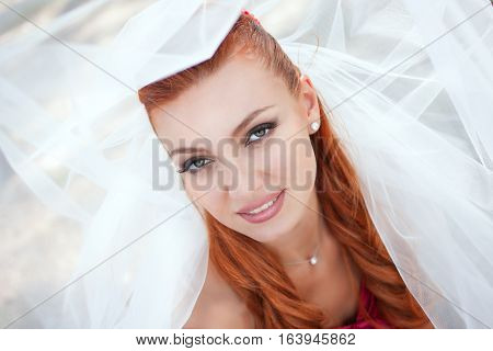 beautiful bride in veil close up outside
