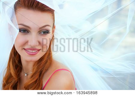 beautiful bride in veil close up outside