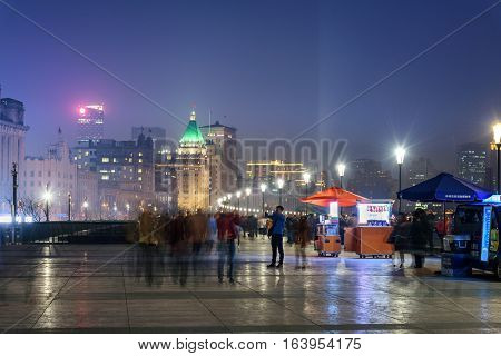 People walking on the promonade in Bund area of Shanghai China.