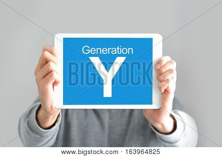 Y generation concept with young man holding a digital tablet