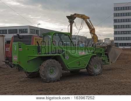 RAUNHEIM, KELSTERBACH, GERMANY-JANUARY 03, 2027: Green telescopic loader on a construction site