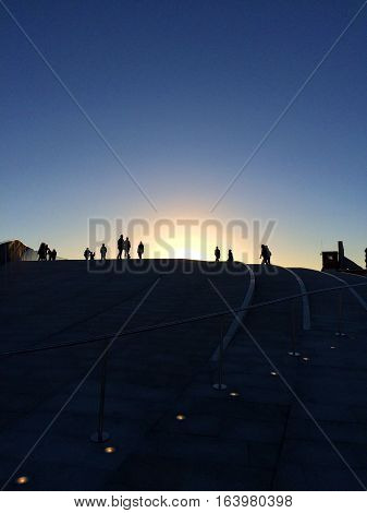 Silhouette of people at the top of the MOMA in Lisbon