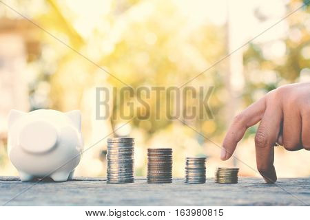 A boy and cion on old wood and tree bokeh background with sunlight a color of vintage tone concept save money
